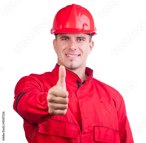 Photo: Young smiling fireman with hard hat and in full uniform Young smiling fireman with hard hat and in full uniform