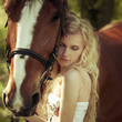 beautiful girl hugging a horse