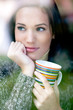 Portrait of a beautiful young woman with a cup of tea coffee loo