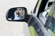 Photo: Male Driver Seen Through Side-View Mirror Of Car. Male Driver Seen Through Side-View Mirror Of Car.