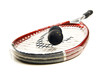 Close up of a squash racket and balls on white