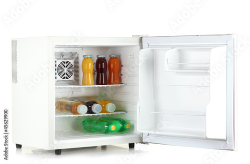 Photo: mini fridge full of bottles of juice, soda and fruit isolated mini fridge full of bottles of juice, soda and fruit isolated