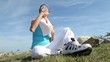 Woman in fitness outfit drinking water from bottle