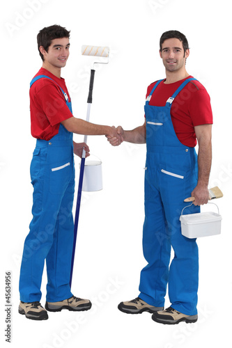 Photo: duo of craftsmen shaking hands duo of craftsmen shaking hands