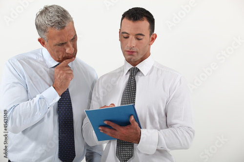 Photo: Two employees going over contract Two employees going over contract
