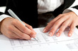 Female hands with pen reviewing document.