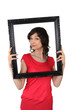 brunette red tunic holding frame