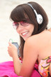 Girl listening to music on the beach