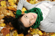 Woman lying on the leaves in the park