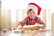 Little boy with rolling pins baking and having fun
