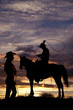 Cowboy on horse swinging rope