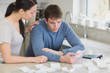 Couple calculating bills in kitchen