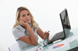 Young woman at a laptop with charts