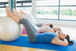 Women doing sit ups with exercise ball