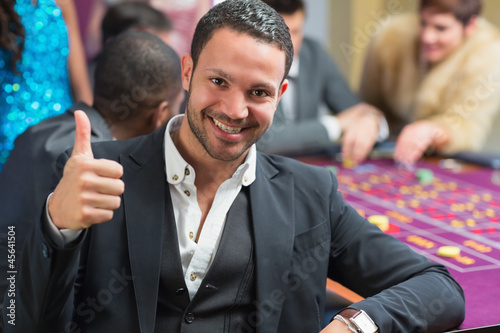 Photo: Smiling an thumbs up at roulette table Smiling an thumbs up at roulette table