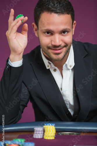Photo: Man holding chip between his fingers Man holding chip between his fingers