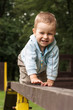 Photo: Happy young boy crawling on the ladder Happy young boy crawling on the ladder