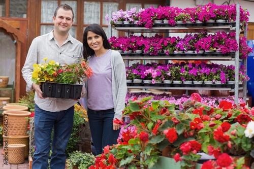 Photo: Happy couple holding tray of plants Happy couple holding tray of plants