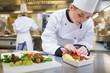Photo: Chef putting a strawberry in the fruit salad Chef putting a strawberry in the fruit salad