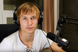 Male dj working in front of a microphone on the radio