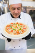 Chef smelling pizza