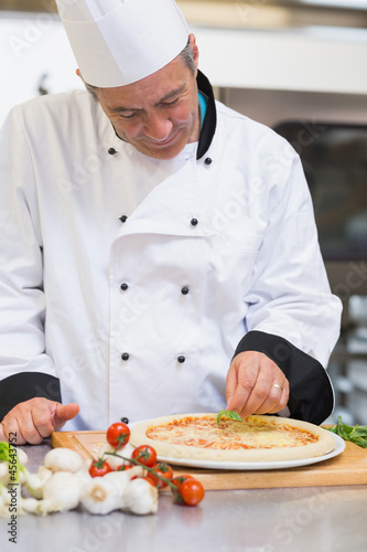 Photo: Happy chef making pizza Happy chef making pizza