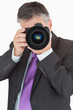 Businessman using digital camera