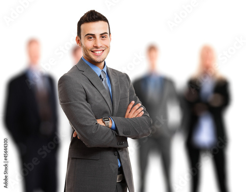 Photo: Businessman in front of his team Businessman in front of his team