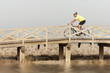 Photo: Mature male riding a bicycle over a bridge Mature male riding a bicycle over a bridge