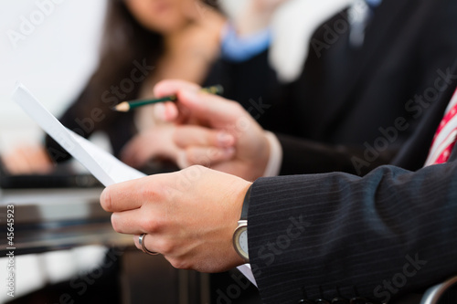 Photo: Business people during meeting in office Business people during meeting in office