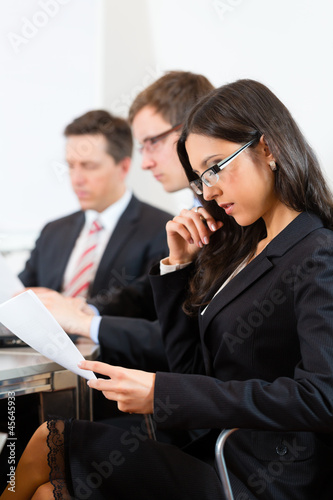 Photo: Business people during meeting in office Business people during meeting in office