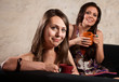 Smiling Ladies on Sofa with Mugs