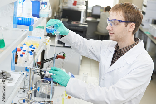 Photo: Man chemist scientist researcher in laboratory Man chemist scientist researcher in laboratory