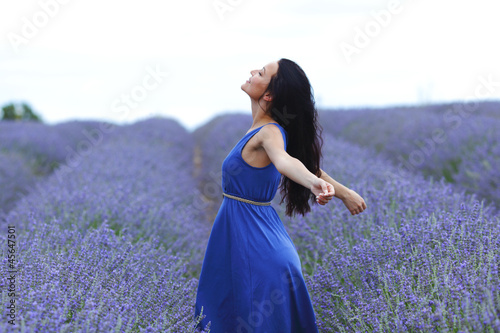 Photo: Woman standing on a lavender field Woman standing on a lavender field