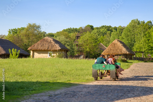 Photo: People sitting in the wooden cart People sitting in the wooden cart