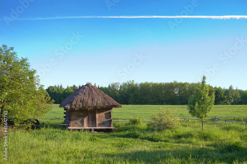 Photo: Old rural house with a straw roof Old rural house with a straw roof