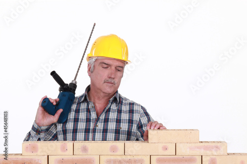 Photo: A mason with a drill. A mason with a drill.