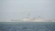 Modern military warship leaving port