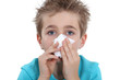 Young boy blowing his nose