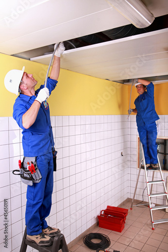 Photo: Electricians in room under construction Electricians in room under construction