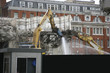 Large jackhammer smashing buildings