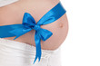 Pregnant belly with blue ribbon
