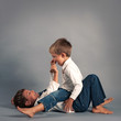 Two young brothers fighting for fun.
