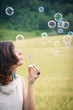 Romantic portrait of young woman with soap balloons.