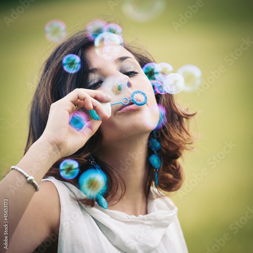 Photo: Romantic portrait of young woman with soap balloons. Romantic portrait of young woman with soap balloons.