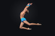 Young woman in gymnast suit posing