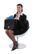 Businesswoman pulling out a document from her briefcase