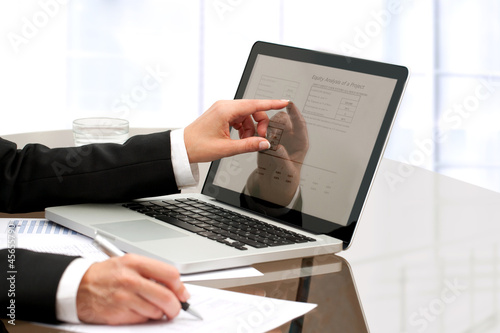 Photo: Female business hands working on table. Female business hands working on table.