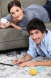 couple reading newspaper at home