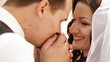 Groom kisses hands bride